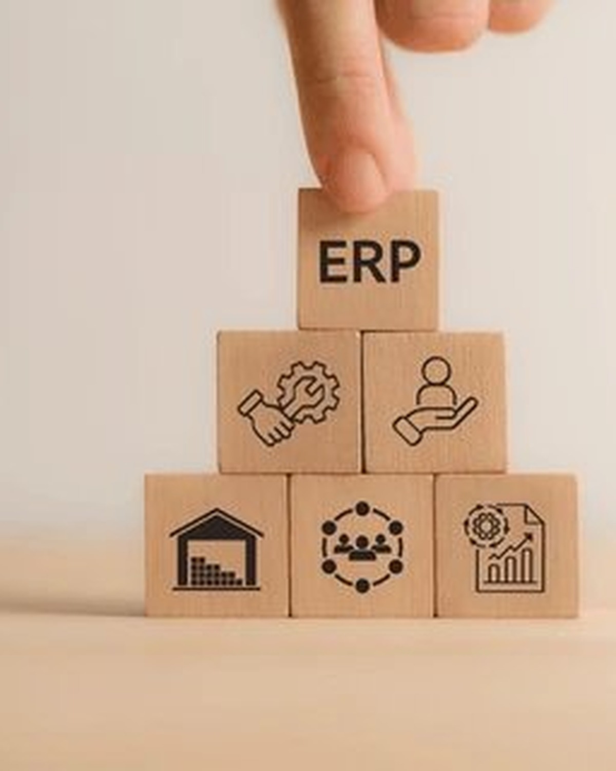 ERP — wooden blocks with business icons stacked in pyramid form